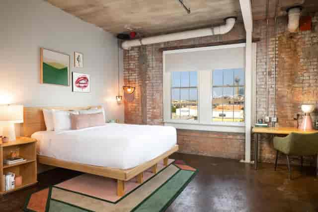 Haven Room at Canvas Dallas Hotel: stylish workspace with natural light, perfect for events.