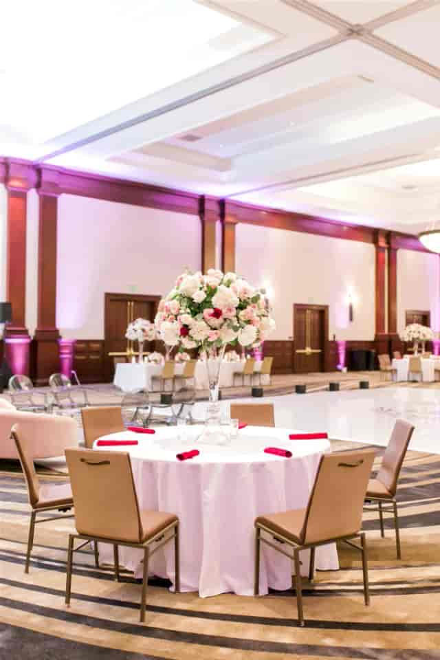 Elegant Grand Ballroom with tall floral centerpieces for upscale events and celebrations.