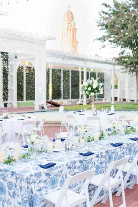 Elegant outdoor Grand Ballroom setup with floral centerpieces for weddings or upscale events.