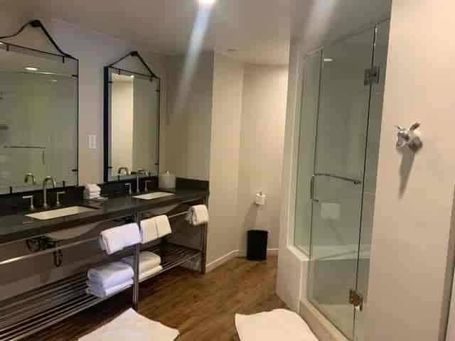 Modern restroom at The Loft, dual sinks, ideal for events and meetings, luxury amenities.