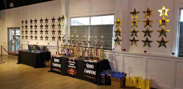 Recognition ceremony at The Rustic, with awards on display and festive star decorations.