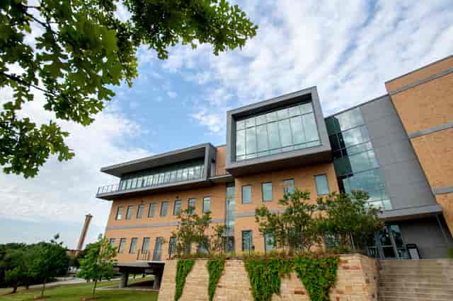 Modern SB Hall at University of Dallas, featuring large windows for vibrant events.