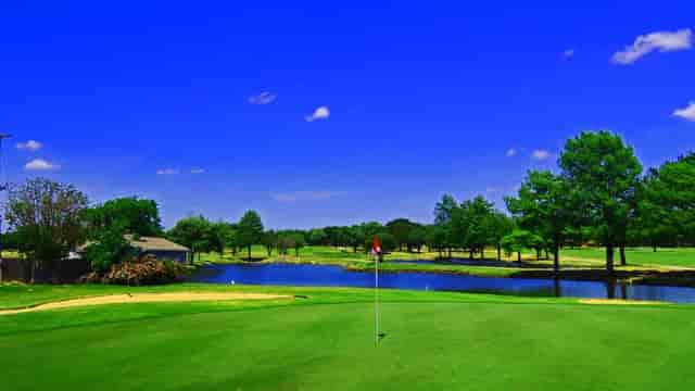 Brookhaven Country Club golf course with a serene lake, perfect for corporate retreats.
