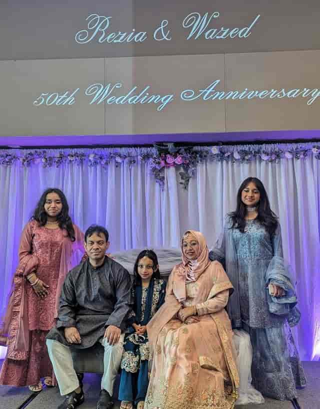 Family gathering in Grand Hall with elegant decorations for milestone celebrations.