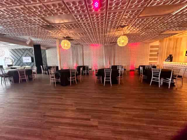 Elegant Frisco Hall venue with stylish black and white tables for celebrations and networking.