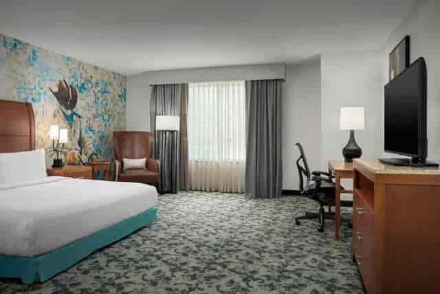 Comfortable hotel room with natural light, ideal for events and accommodations.