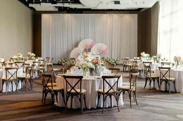 Elegant ballroom with round tables and floral centerpieces for weddings, Dallas events.
