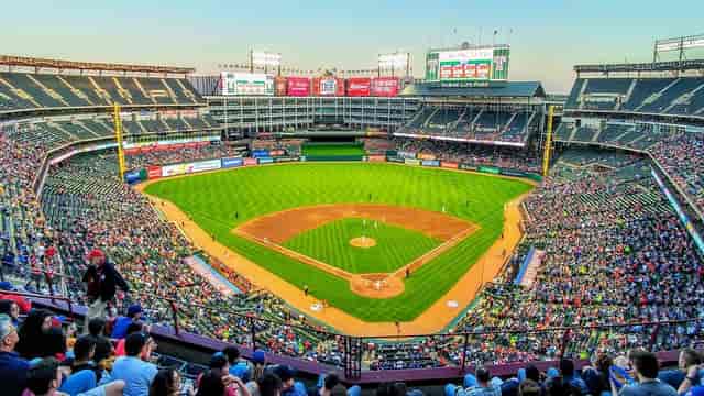 "Vibrant Globe Life Field stadium with enthusiastic fans at a baseball event."
