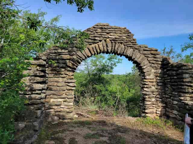 Murray A. James Auditorium stone archway, lush greenery, ideal for events and ceremonies.