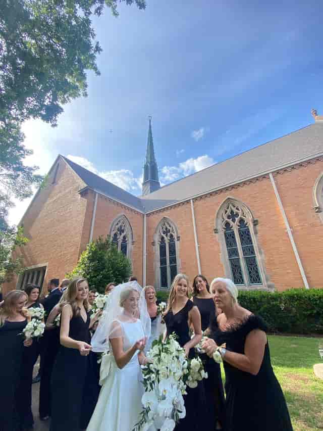 Wedding scene at Kessler Park UMC, featuring bride with bouquet and elegant bridesmaids.