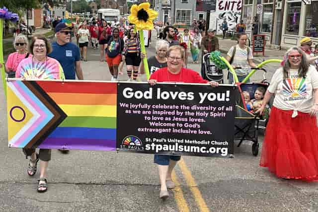 Wesley Center parade at St. Paul's UMC celebrating community and diversity with colorful signs.