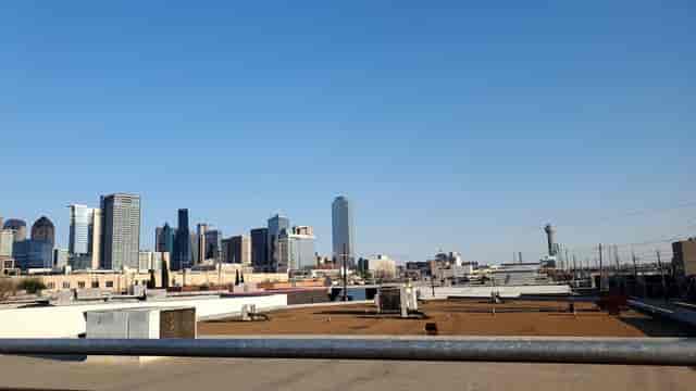 Rooftop patio with city skyline, ideal for outdoor meetings and events.