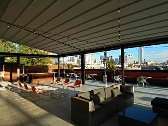 Modern rooftop patio on Dragon St. with city skyline, ideal for events and receptions.