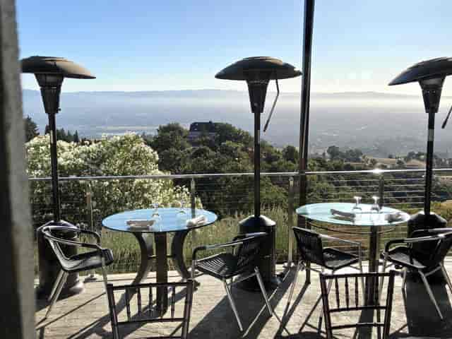 Outdoor restaurant venue with elegant glass tables, perfect for meetings and events.