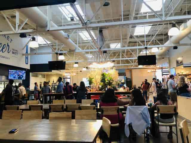 Three Sisters Patio in San Pedro Square Market, featuring a vibrant floral display for events.