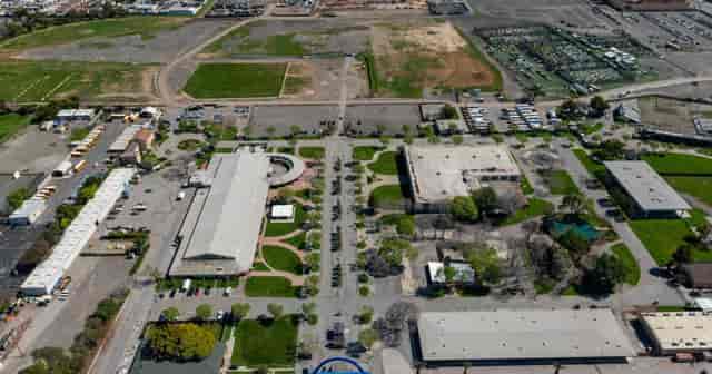 Sprawling green event venue with versatile setup for receptions and gatherings.