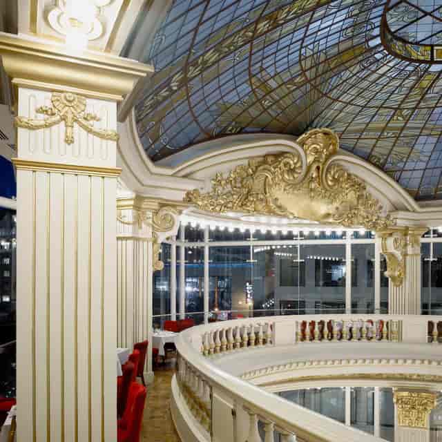 Elegant restaurant venue with grand ceiling, perfect for weddings and upscale events.