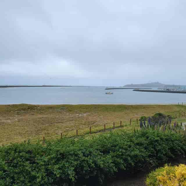 Rose Garden Patio at Beach House Hotel, serene coastal view for events and retreats.