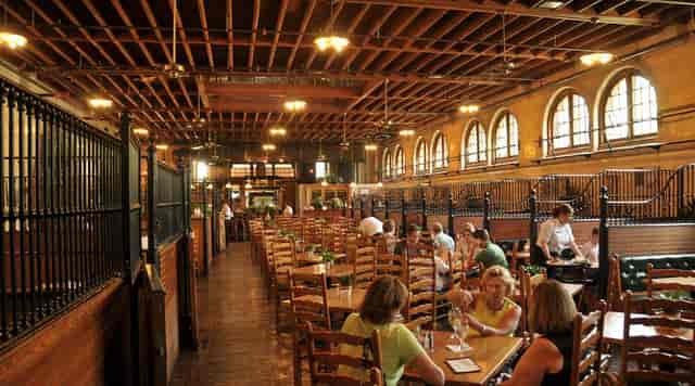 Rustic dining venue with high ceilings at Stable Café Loft, perfect for events and receptions.
