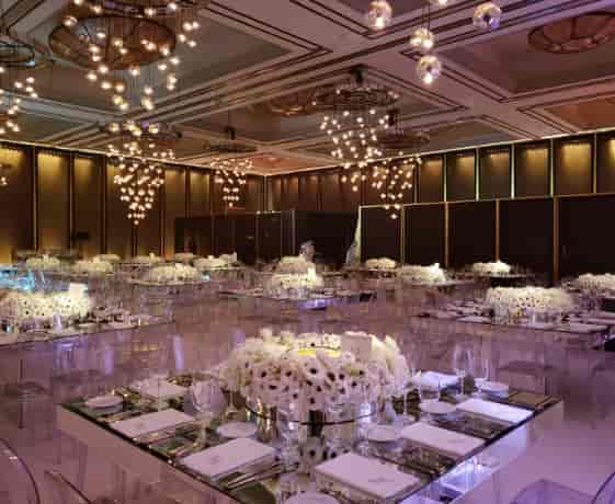 Elegant banquet setup with white floral centerpieces in upscale Fairmont hotel venue.