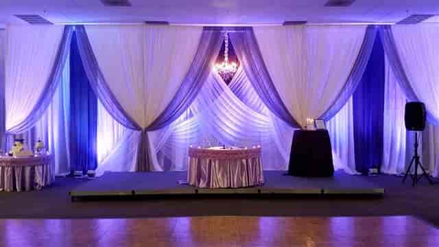 Elegant banquet room with purple draping for weddings and corporate events.