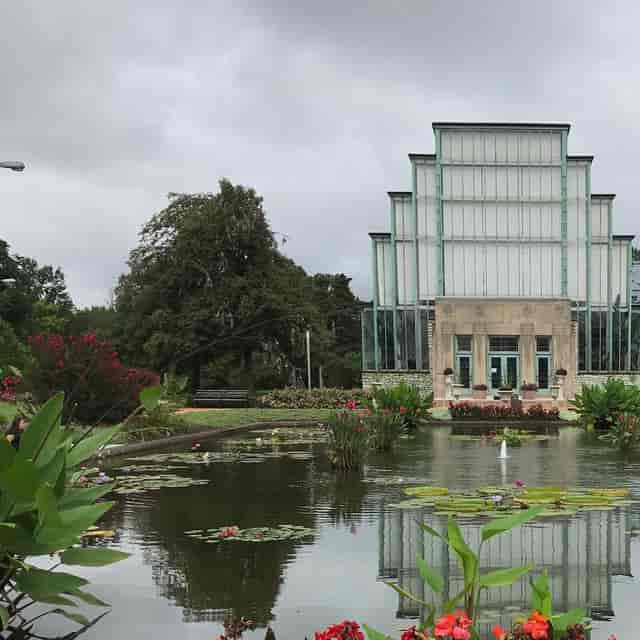 Jewel Box venue with glass structure amid lush gardens for outdoor events and receptions.