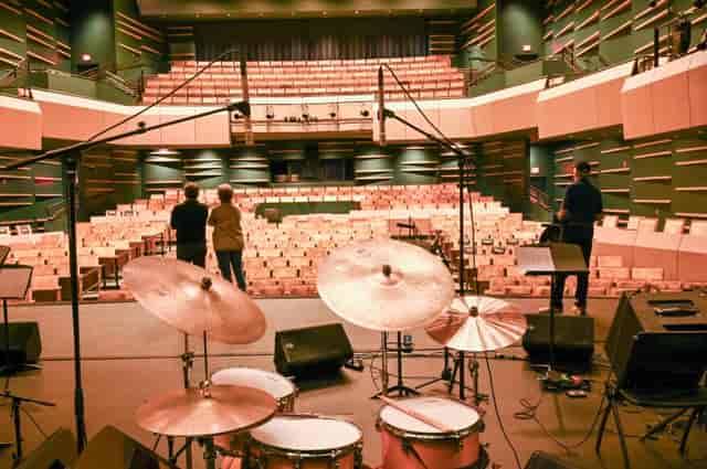 Multipurpose theater stage setup with drum set for concert event at Field Arts & Events Hall.
