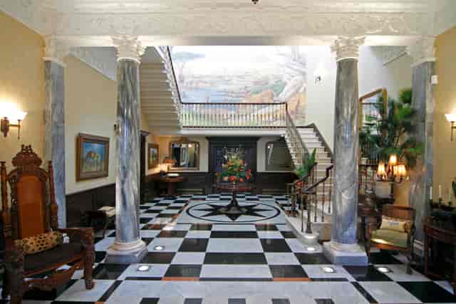 Elegant foyer with grand staircase at Spring Grove House, ideal for events and receptions.