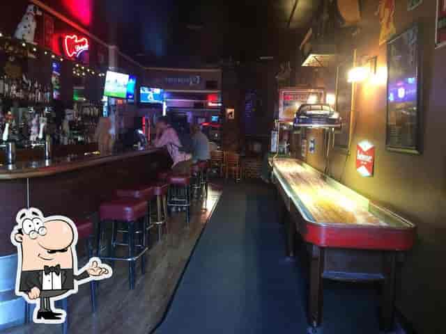 Cozy bar in The Orchid Room, with shuffleboard for networking events and gatherings.