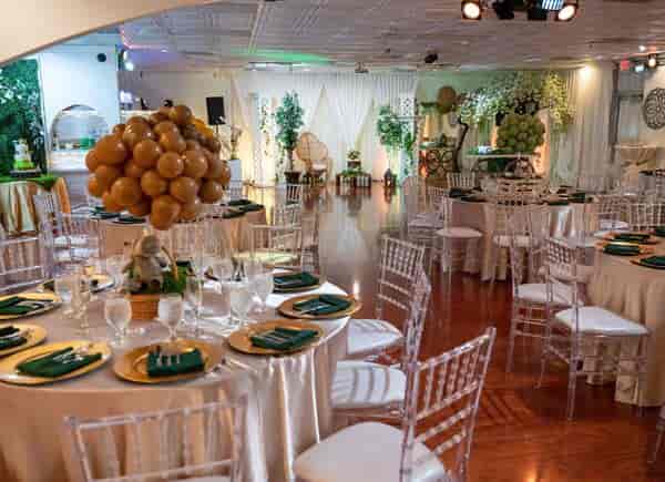 Elegant banquet hall with round tables and modern acrylic chairs for weddings and events.