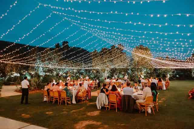 Outdoor wedding chapel with twinkling lights and lush greenery for special events.
