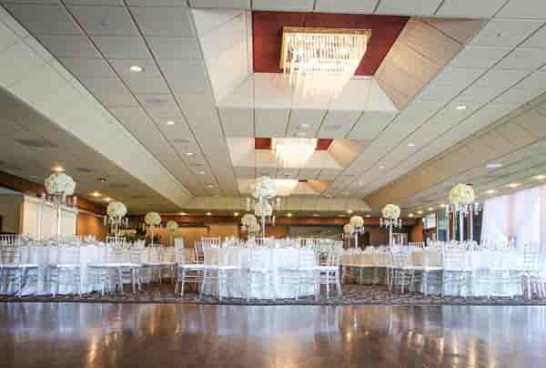 Elegant wedding venue in San Jose with floral centerpieces and chandeliers.
