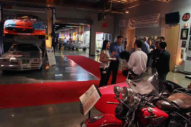 Classic cars on red carpet in vibrant Parkade at Club Auto Sport for automotive events.