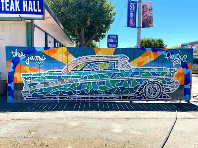Pepper Steak Hall mural with classic car, ideal backdrop for outdoor events and networking.
