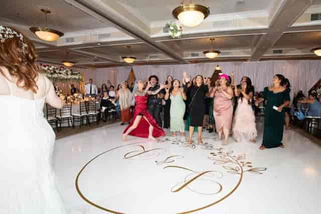 Wedding reception bouquet toss at Campbell Gallery with vibrant energy and joyful atmosphere.