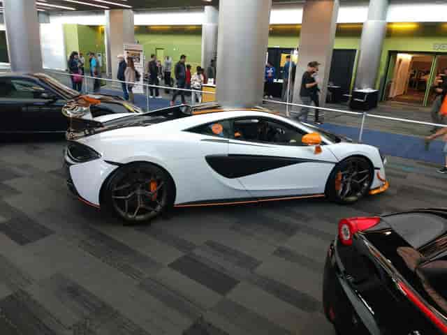 Sleek sports car at San Jose tech expo, blending luxury and technology.