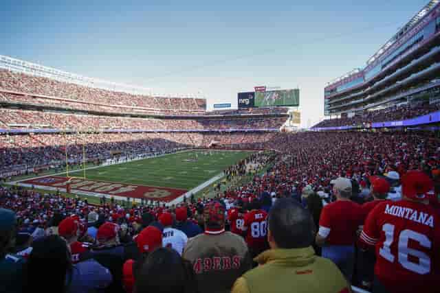 Packed suites at Levi's Stadium during a vibrant sporting event, showcasing excitement.