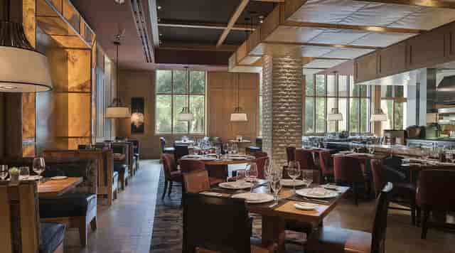 Elegant restaurant venue with warm lighting for corporate meetings and private events.