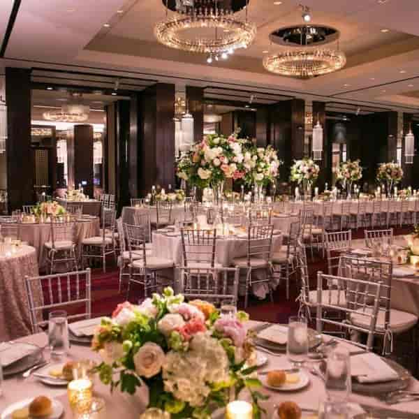 Elegant banquet hall with floral centerpieces, ideal for weddings and corporate events.