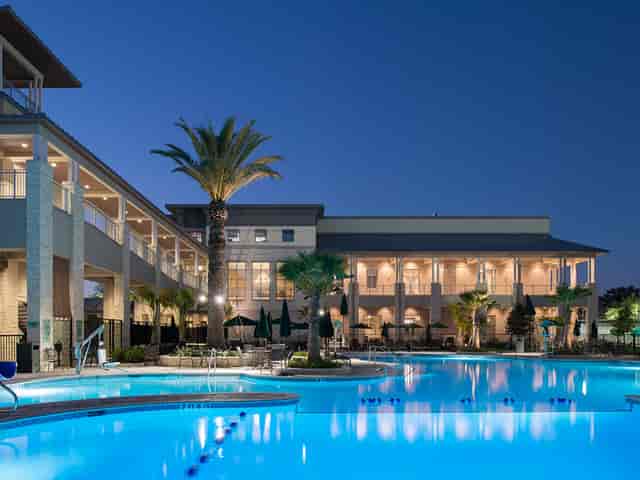 Elegant Wine Room venue with pool and palm trees, perfect for meetings and receptions.