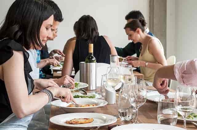 Corporate event dining setup at Jenius Social with elegant glassware for networking.