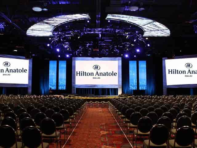 Ballroom setup at Hilton Anatole, Dallas for corporate events with tiered seating.