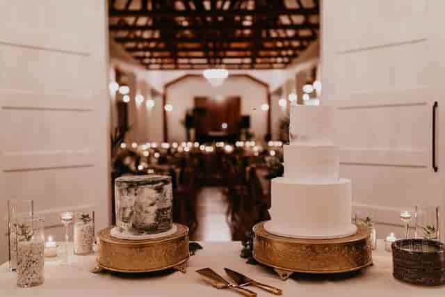 Elegant wedding cakes in a beautifully lit reception space at The Cliff House.