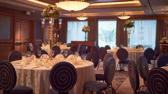 Elegant Nautilus Ballroom with round tables, perfect for weddings and corporate events.