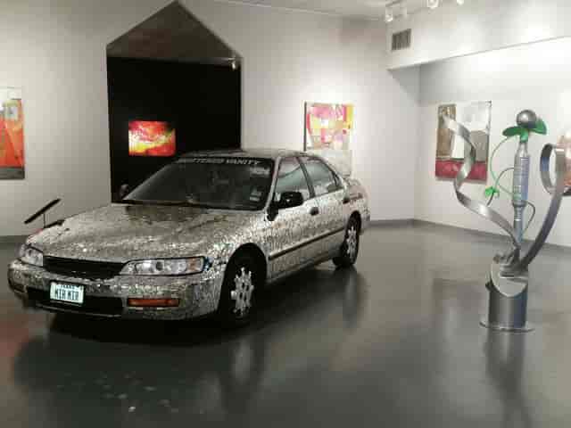 Art Car Museum exhibit: creatively adorned car in gallery, perfect for unique events.