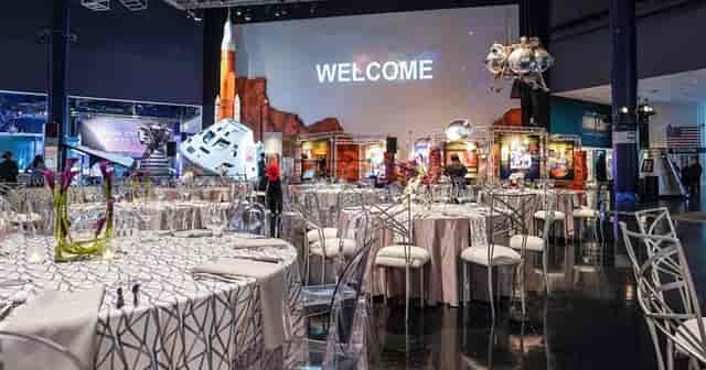 Futuristic event space with chic seating and space-themed decor for networking gatherings.