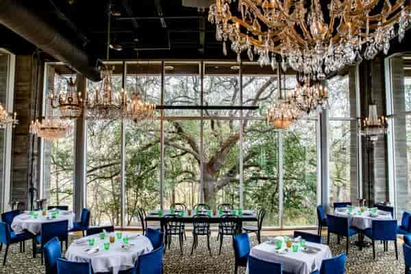 Elegant private dining space with chandeliers for upscale events and meetings.