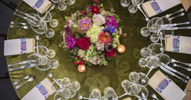 Elegant dining table setup with vibrant centerpiece for sophisticated events.