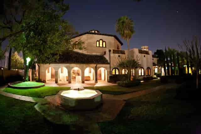 Cloister Room at The Parador, illuminated venue for elegant receptions and evening events.