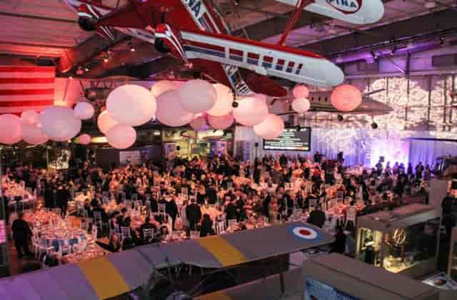 Hamilton Family Auditorium event space with round tables, ideal for networking and celebrations.